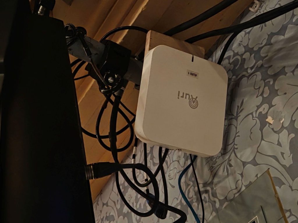 The Auri Auracaster is a box that looks like a WiFi router. It is seen here wired up