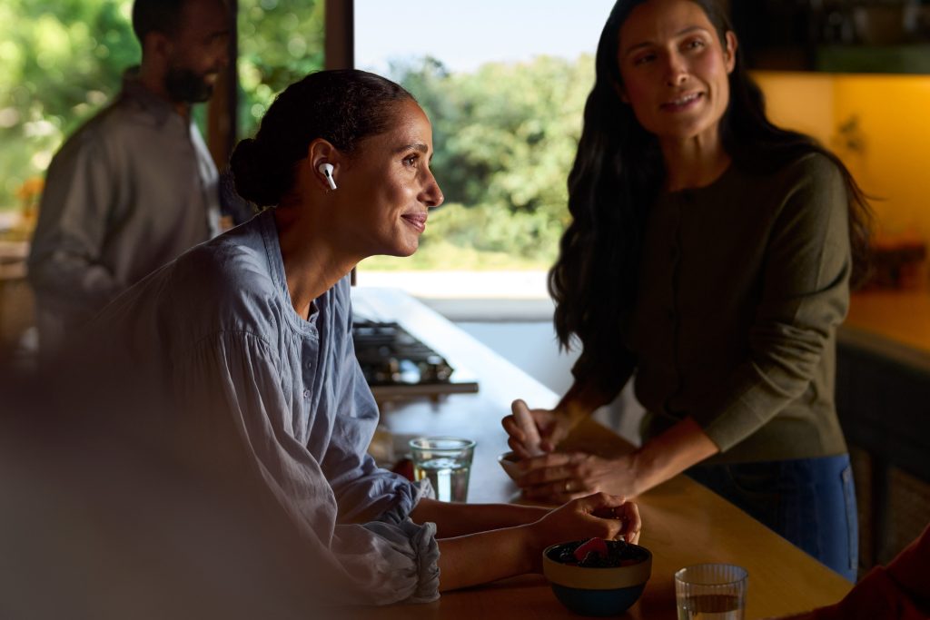 A group of people leaning on a kitchen counter