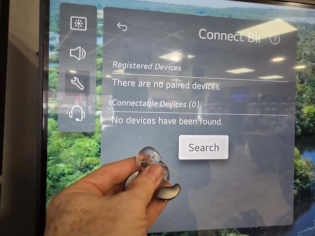No joy! Hearing aids with Auracast built in held up next to a television that has Bluetooth activated. The television cannot see the hearing aids