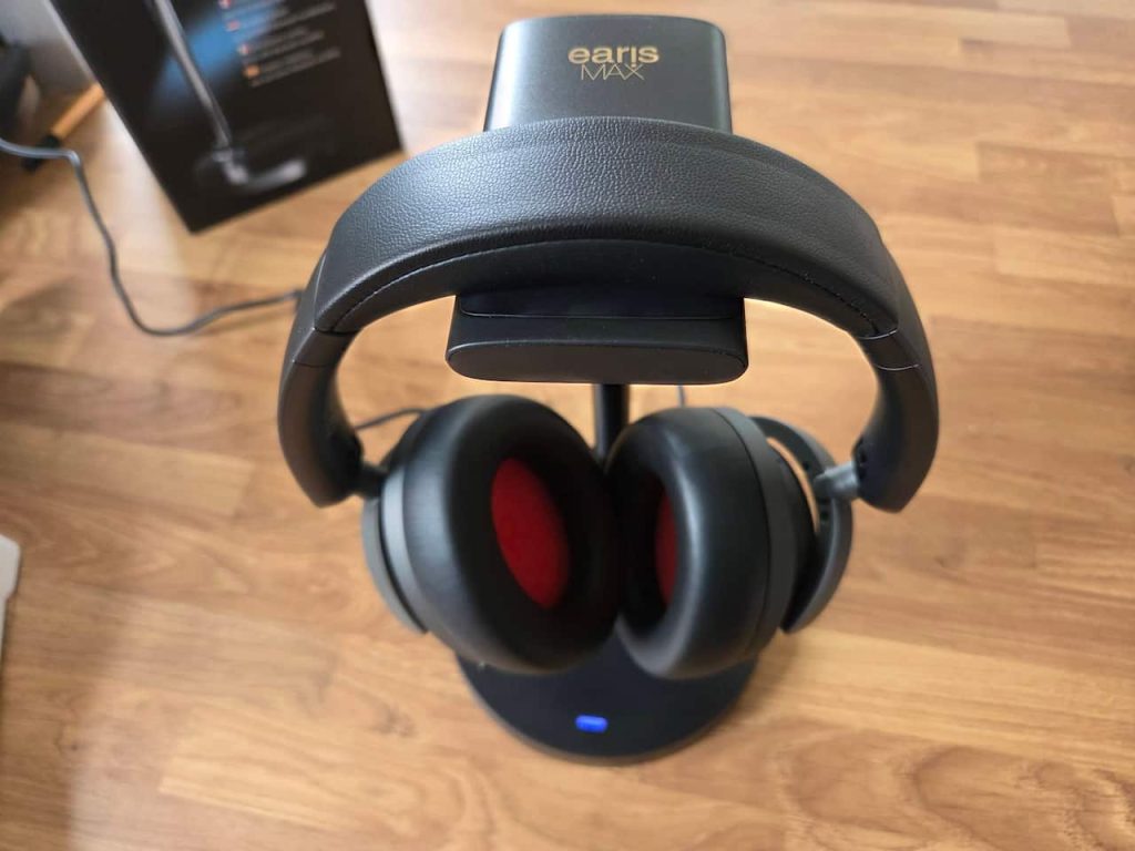 The earisMAX headphones on the charging cradle