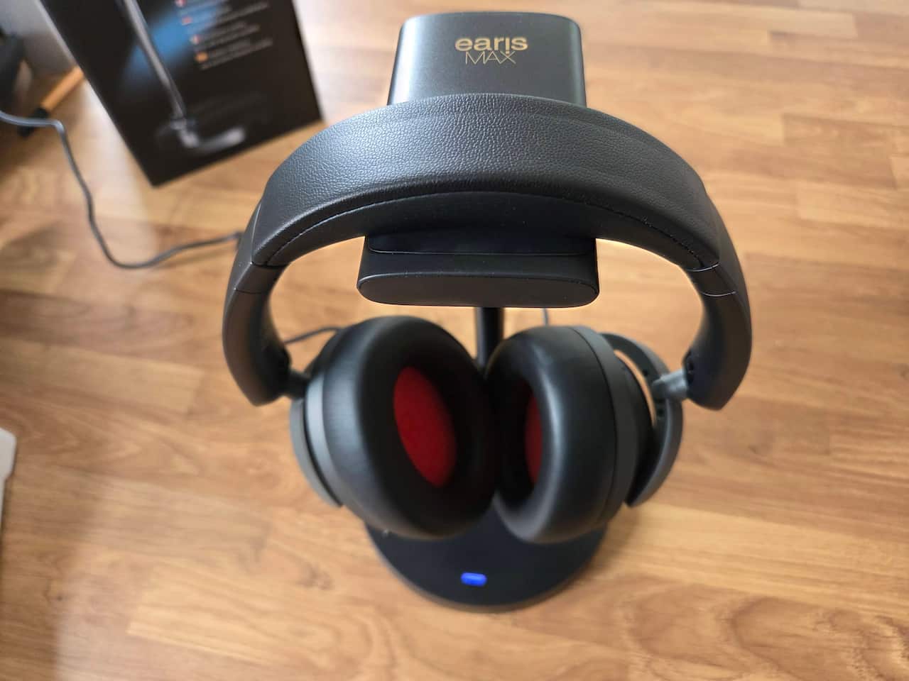 The earisMAX headphones on the charging cradle