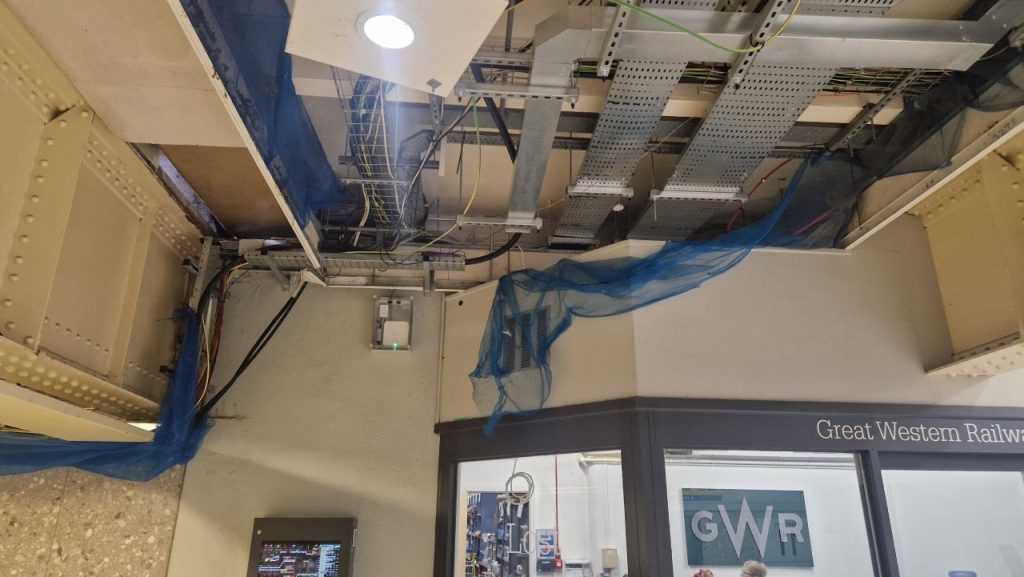 A picture showing an Auri router-style white box installed on the ceiling of Bristol Temple Meads railway station