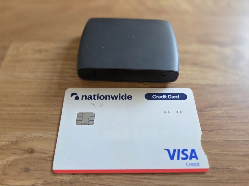 The GN ReSound TVStreamer+ above a credit card, showing its small size