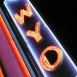 A neon sign with the letters WYO