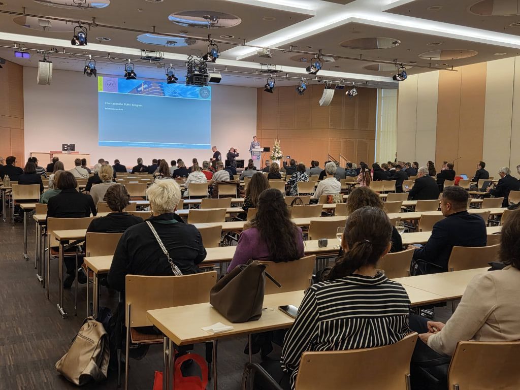 The lecture hall at EUHA with some delegates sitting at tables