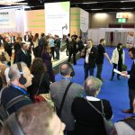 People wearing headphones and listening to an Auracast at the EUHA Congress