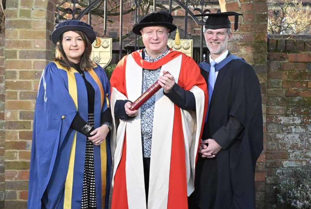 The University of Reading presented an honorary degree to Aurahear.co.uk's Phil Creighton (pictured centre). All three people are wearing ceremonial robes for an academic institution.