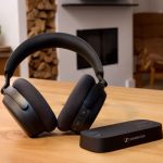 the Sennheiser RS 275 TV Headphones and BTA1 TV Transmitter sitting next to each other in a wooden table