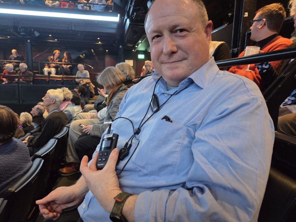 Phil Creighton wearing the Williams AV Auracast receiver at the National Theatre
