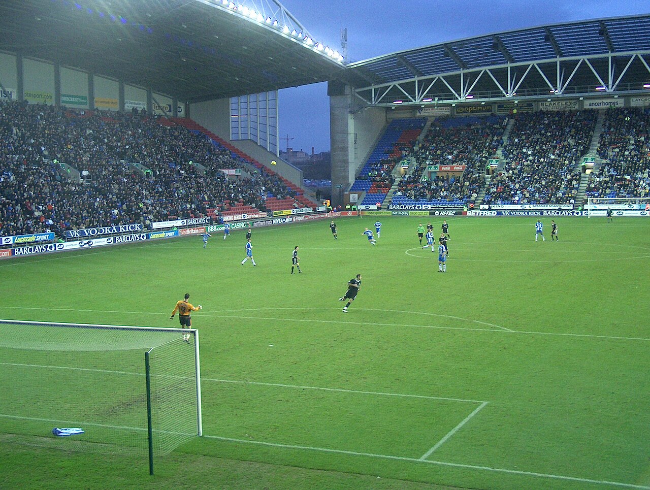 The JJB Stadium with a game of football being played