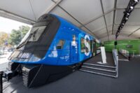 Walk in model of Munich s new XXL S Bahn – A large blue and black mock-up of the front and side of a Munich S-Bahn train inside a white marquee with a boarding ramp.