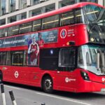 A London bus on a street.