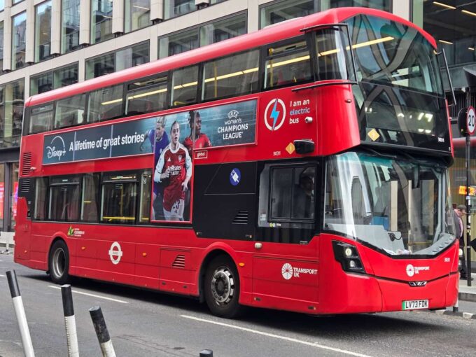 A London bus on a street.