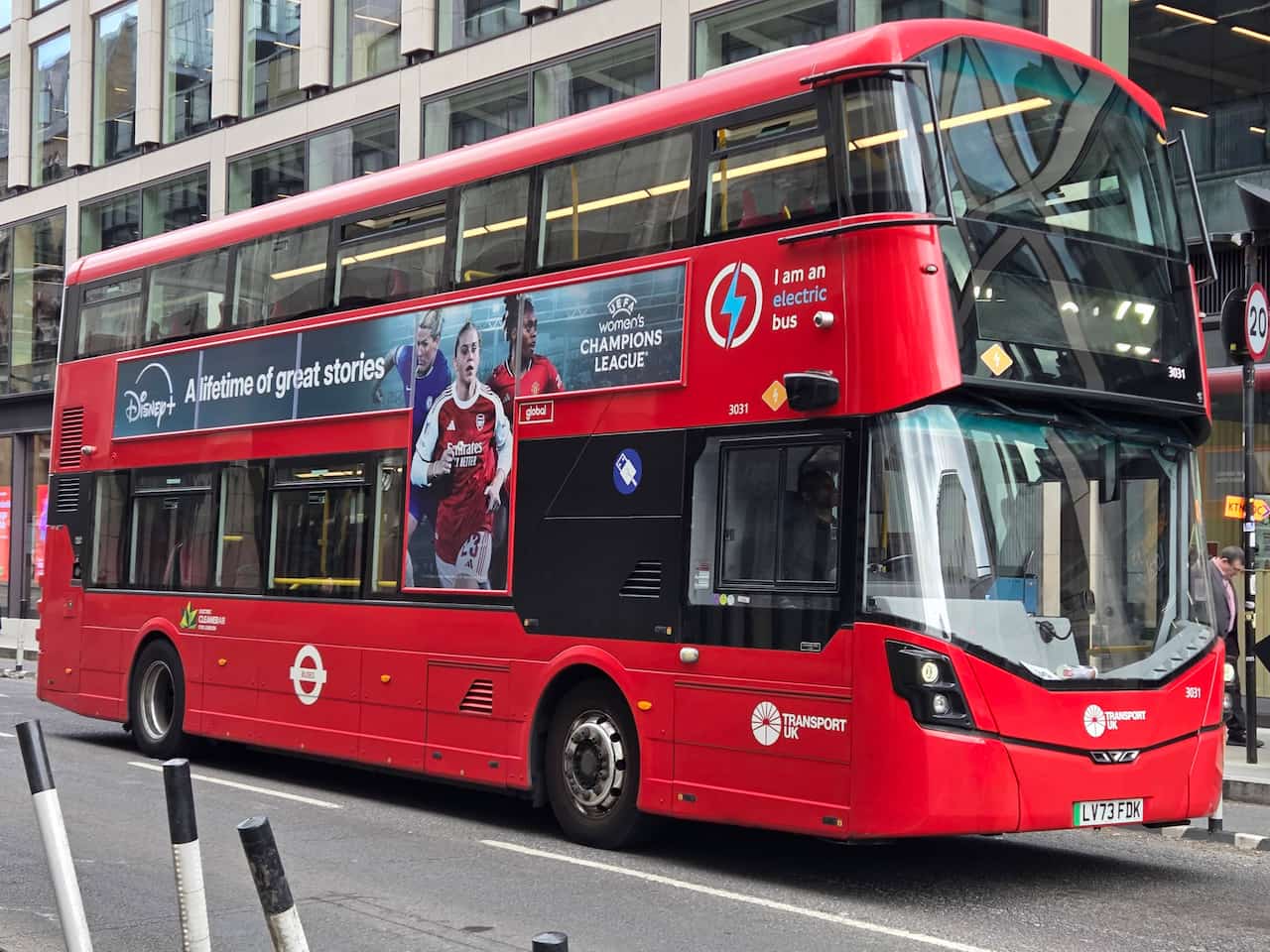 A London bus on a street.