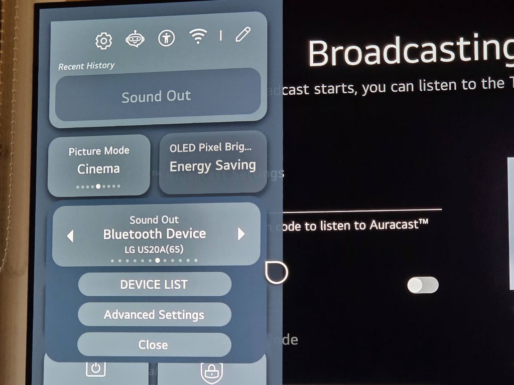 A quick settings side panel overlaid on the left side of the television screen. The menu shows current device options including Picture Mode set to Cinema and Sound Out configured to a Bluetooth device identified as LG US20A.