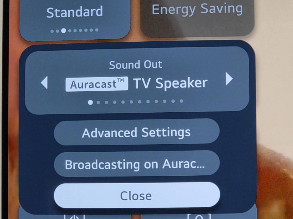 An expanded look at the quick settings menu on the LG television screen focusing on the Sound Out box. The menu lists the Bluetooth Device LG US20A along with interactive buttons for Device List, Advanced Settings, and Close.