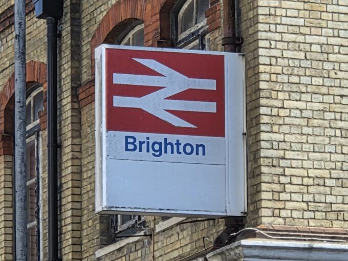 A sign showing the British Rail emblem and the word 'Brighton' underneath it