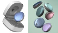 A split image showcasing the Cochlear Osia 3 Sound Processor. On the left, a circular, metallic blue sound processor sits slightly levitated above its open, white and grey plastic charging case. On the right, a collection of six identical circular sound processors float against a soft sage green background, highlighting various metallic colour options including dark blue, turquoise, light blue, pink, and purple.
