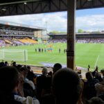 Fans inside a football stadium with restricted views