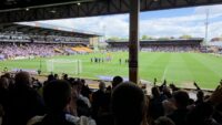 Fans inside a football stadium with restricted views