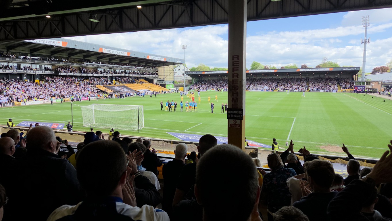 Fans inside a football stadium with restricted views