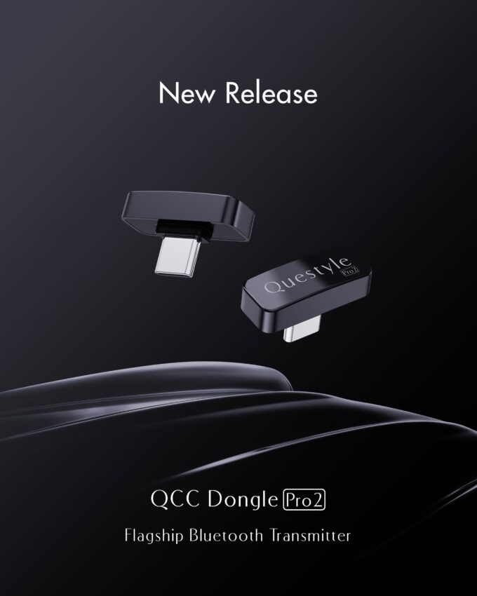 A promotional poster on a dark background showing two compact black USB-C Bluetooth transmitters floating above a glossy black surface. White text reads "New Release" at the top and "QCC Dongle Pro2 - Flagship Bluetooth Transmitter" at the bottom. One dongle shows the silver USB-C connector, while the other shows the Questyle Pro2 logo on its top face.