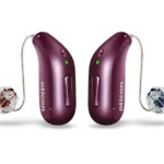 A pair of deep plum Oticon Reveal miniRITE hearing aids featuring clear domes and speaker wires against a white background.